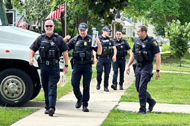 Elgin police officers are holding walk-and-talk events in the weeks leading up to July 4 to encourage people not to set off illegal fireworks, which they say are distressing to people with PTSD and to pets.  (Elgin Police Department)